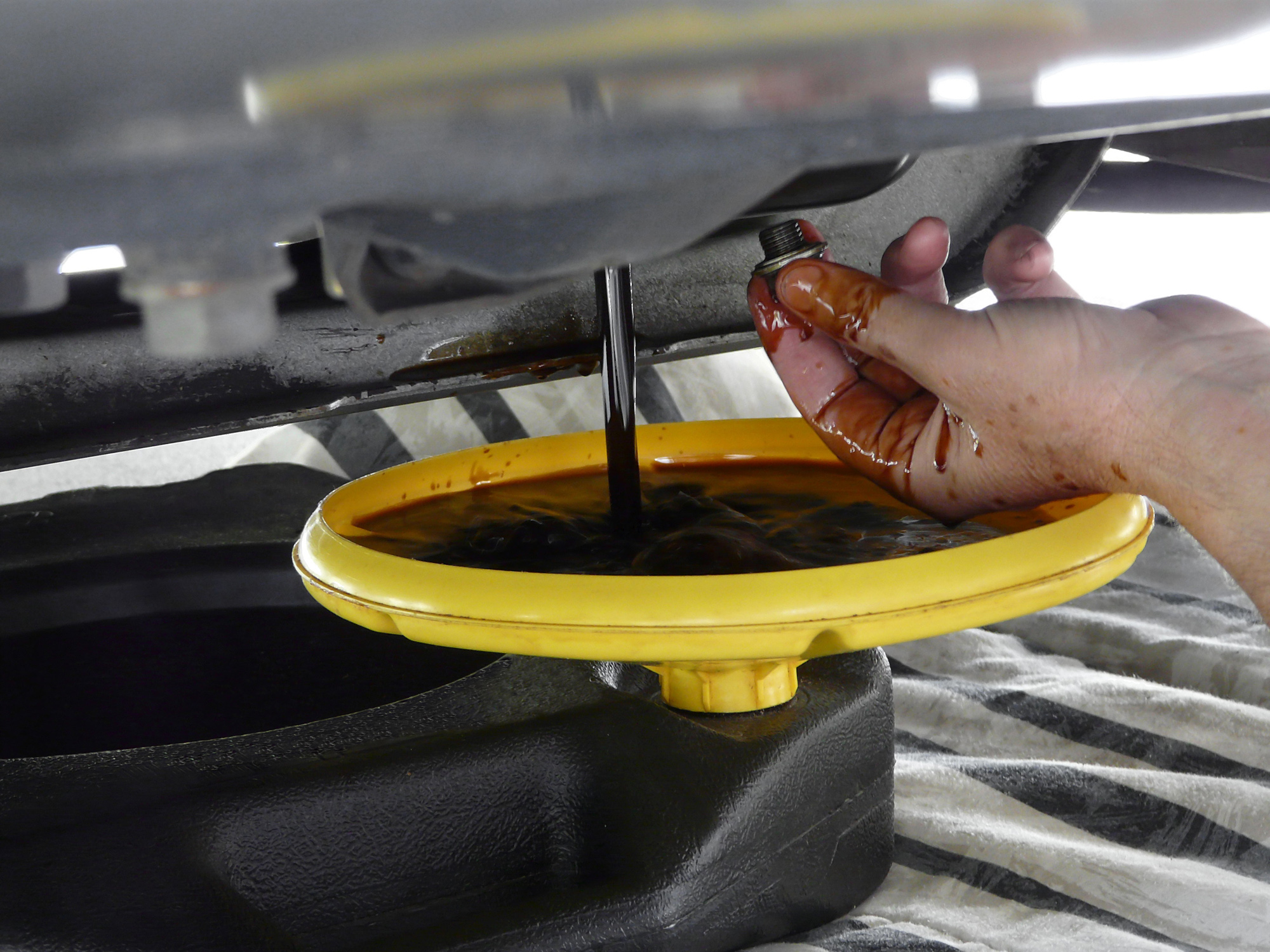 Fluid replacement during an oil change at Auto Tech Center in Ann Arbor MI